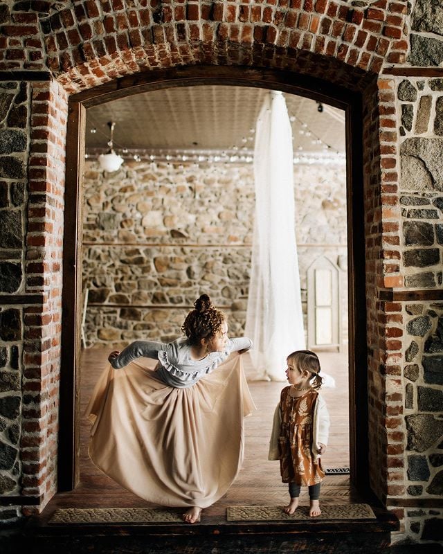 two young girls standing in brick doorway