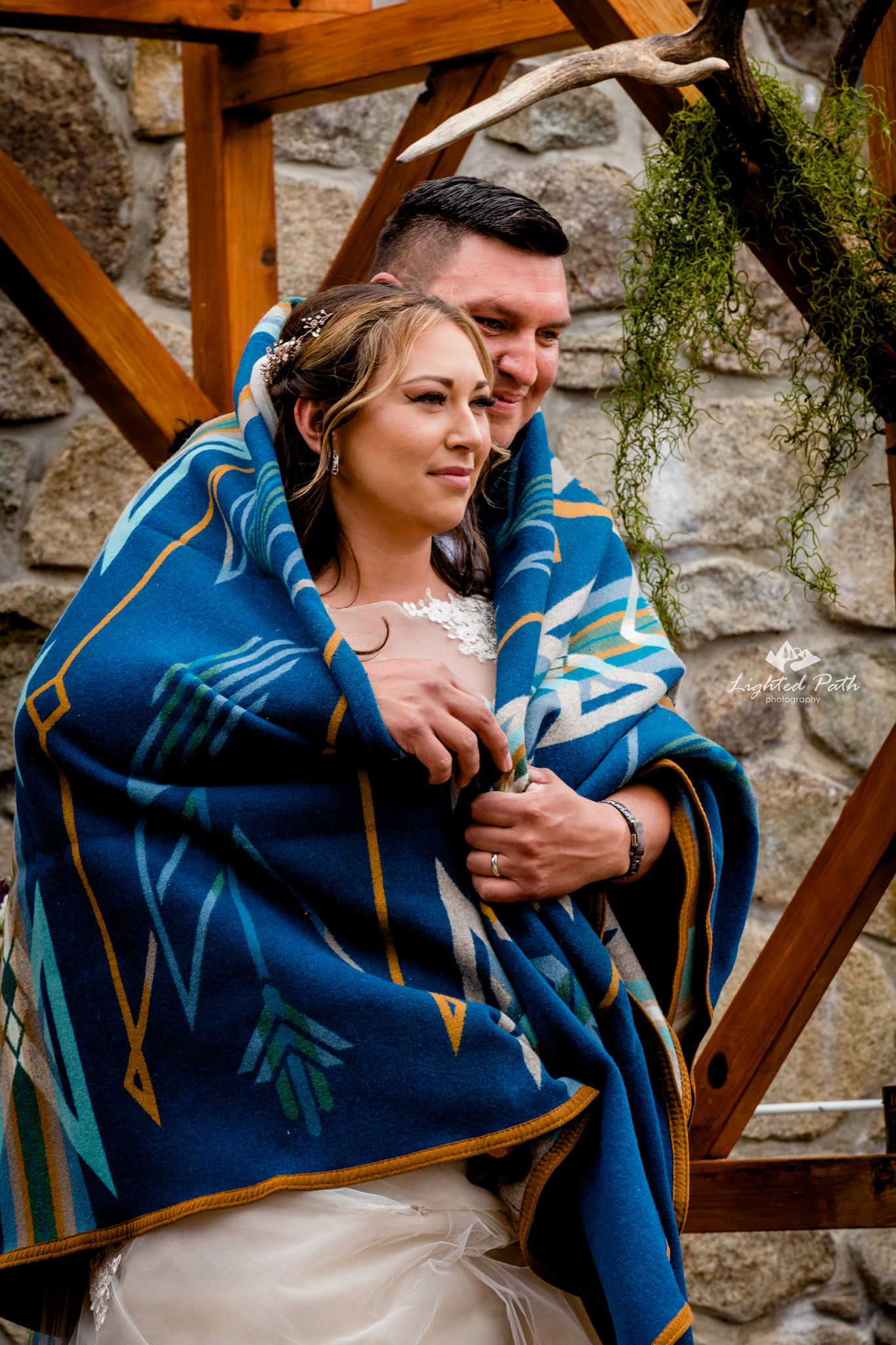 bride and groom wrapped in Western prink blanket