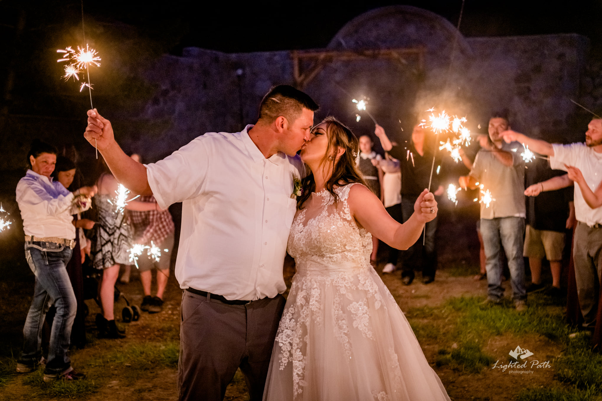 bride and groom kissing during sparkler exit