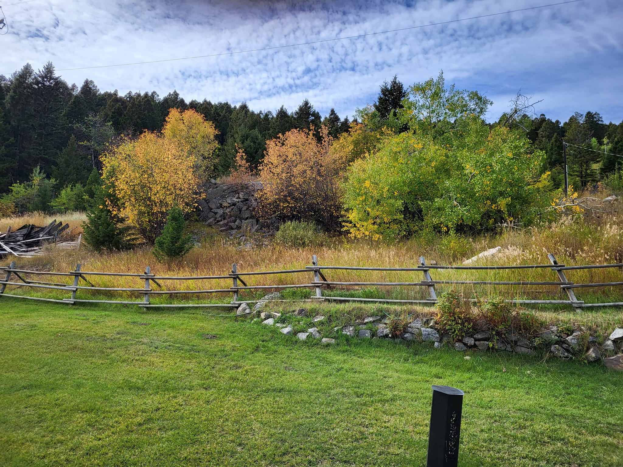 rustic wooden fence surrounded by fall trees