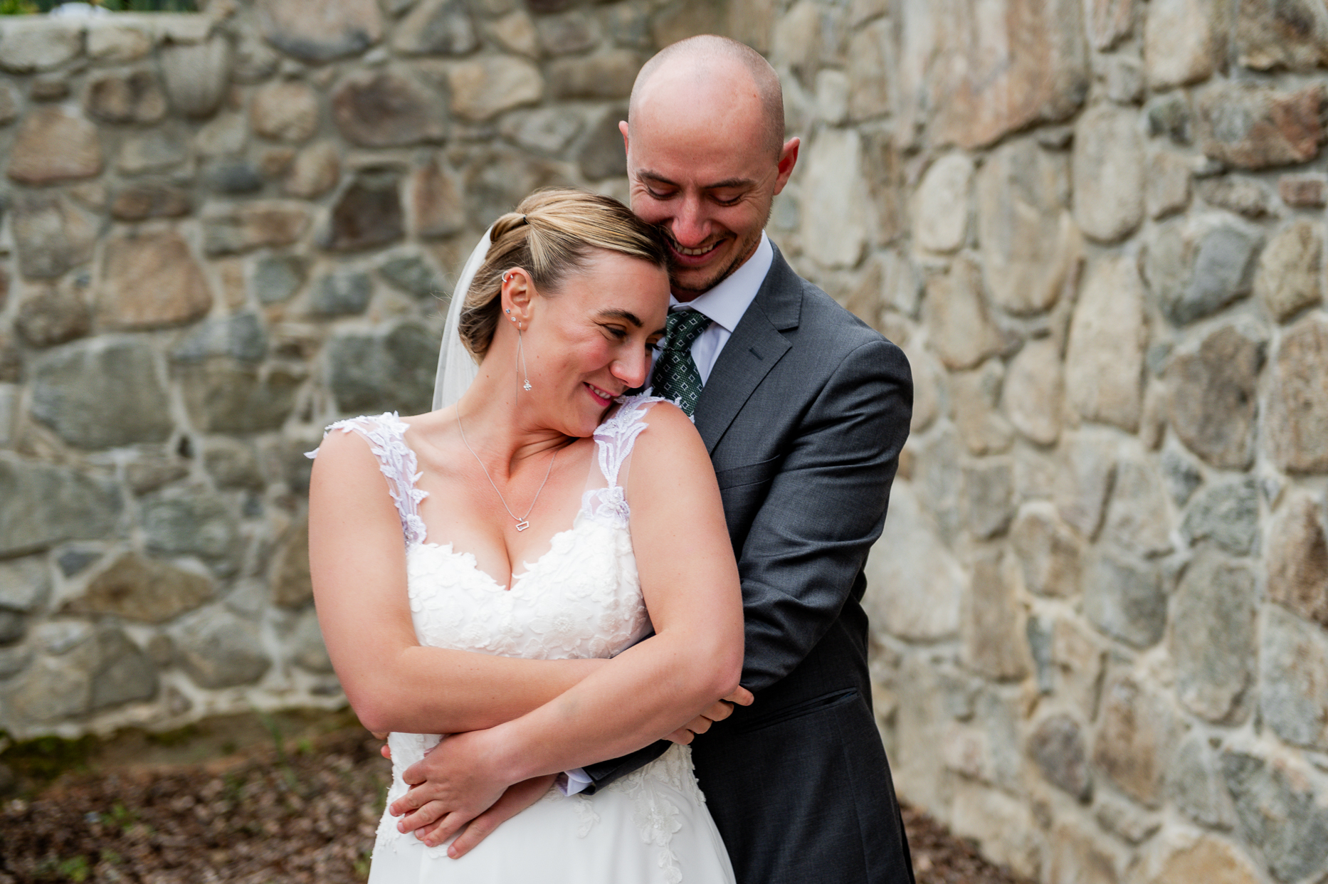 bride and groom smiling and embracing