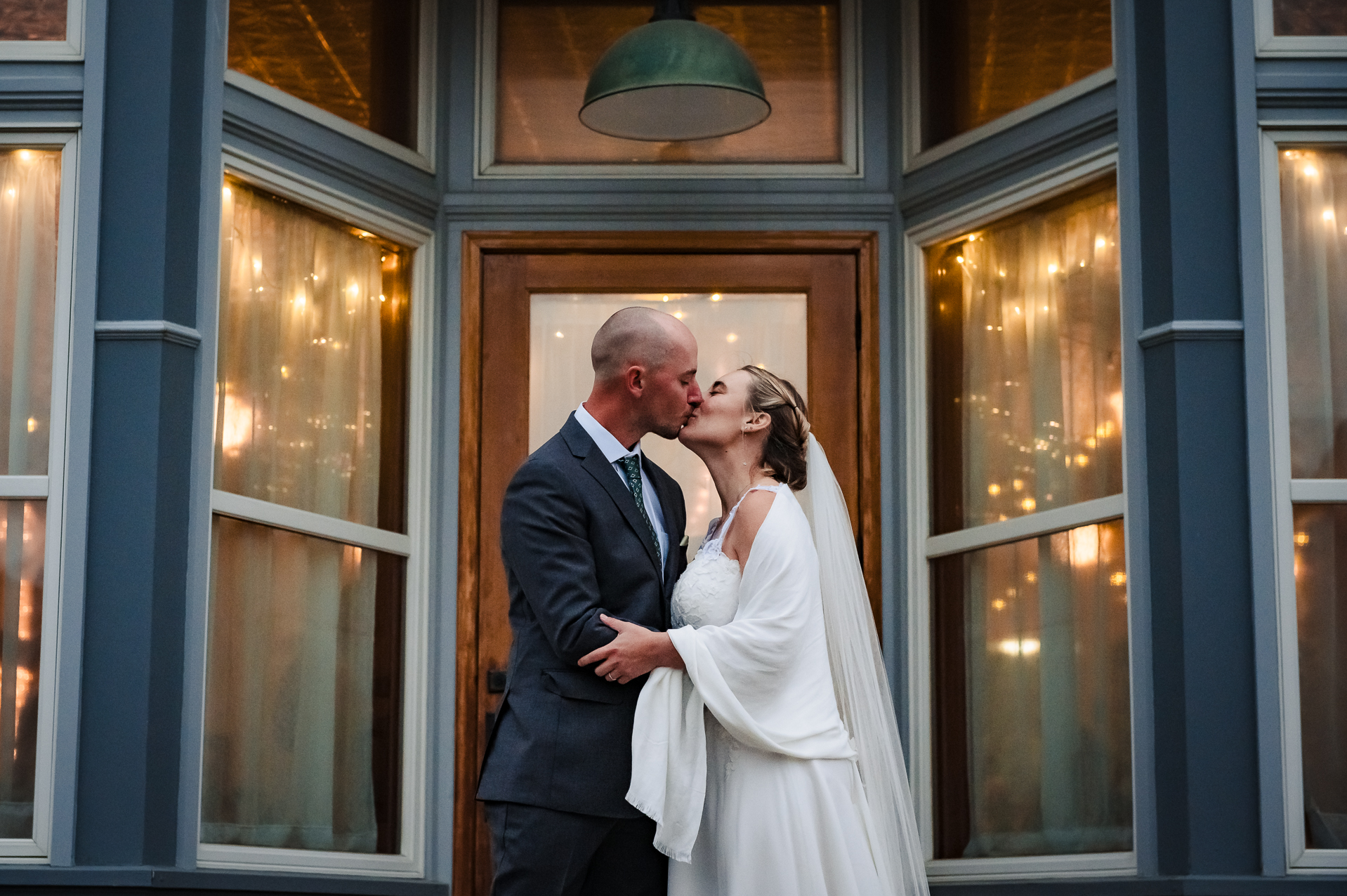 bride and groom kissing in front of Historic Marysville General Store
