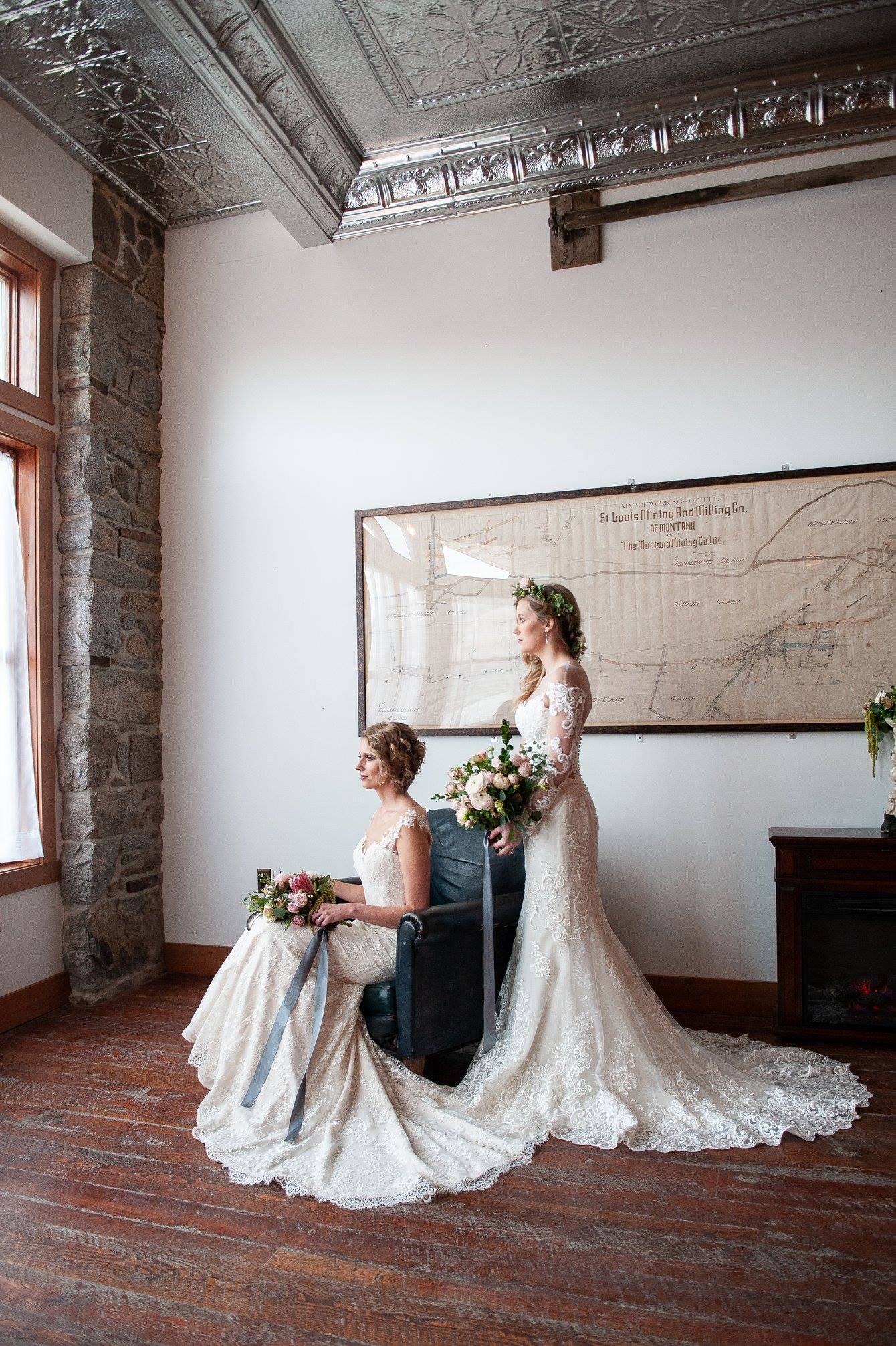 two brides posing in historic wedding venue