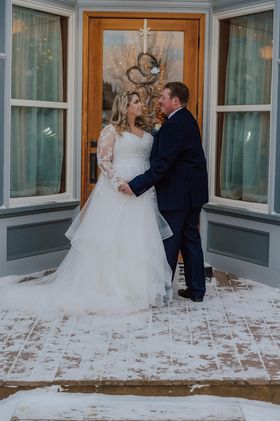 couple kissing in the snow in front of Historic Marysville General Store