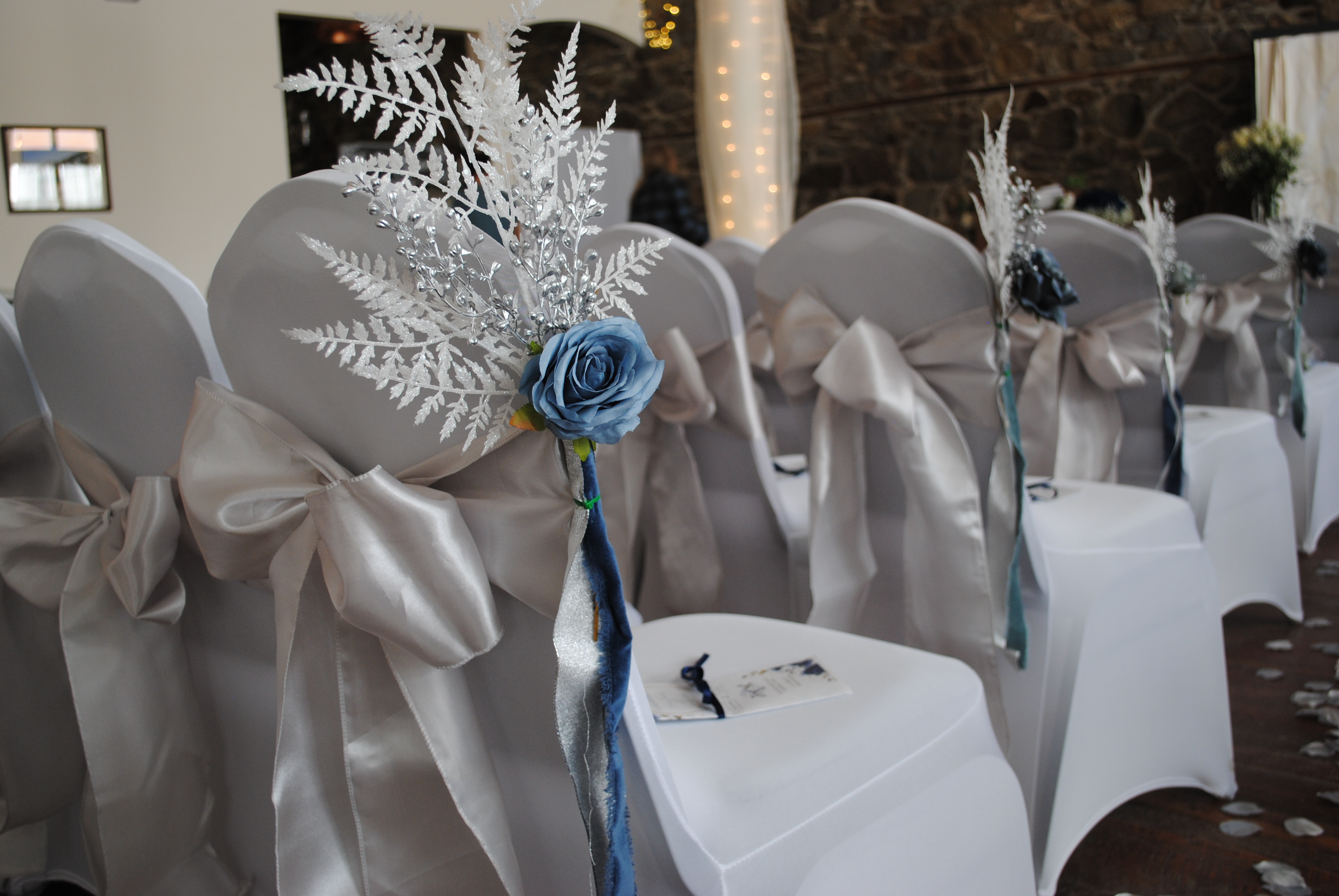 blue roses on wedding ceremony chairs
