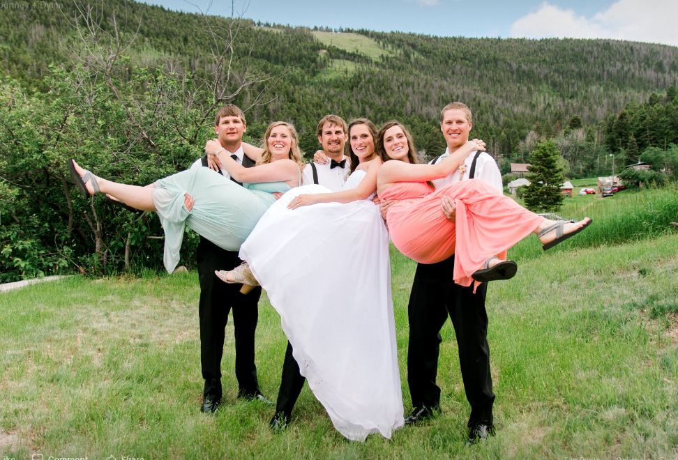 groom holding bride while groomsmen hold bridesmaids