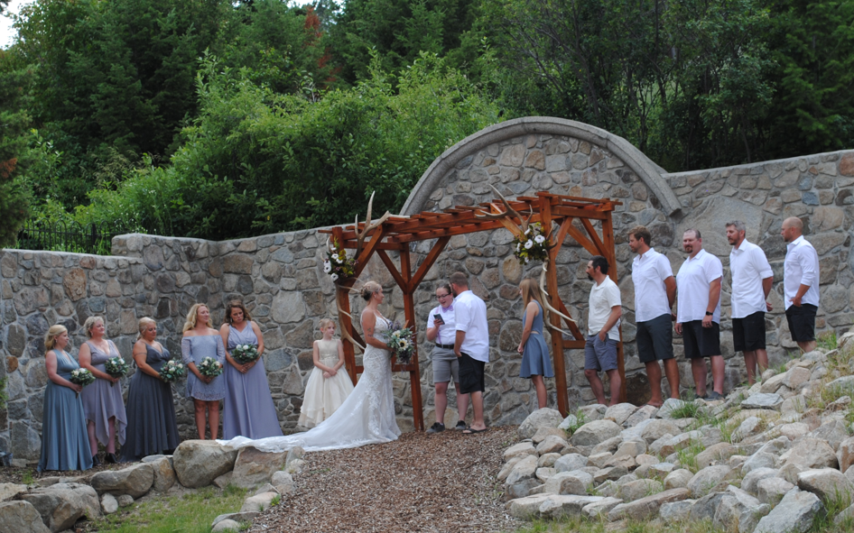 outdoor summer wedding under wooden pergola