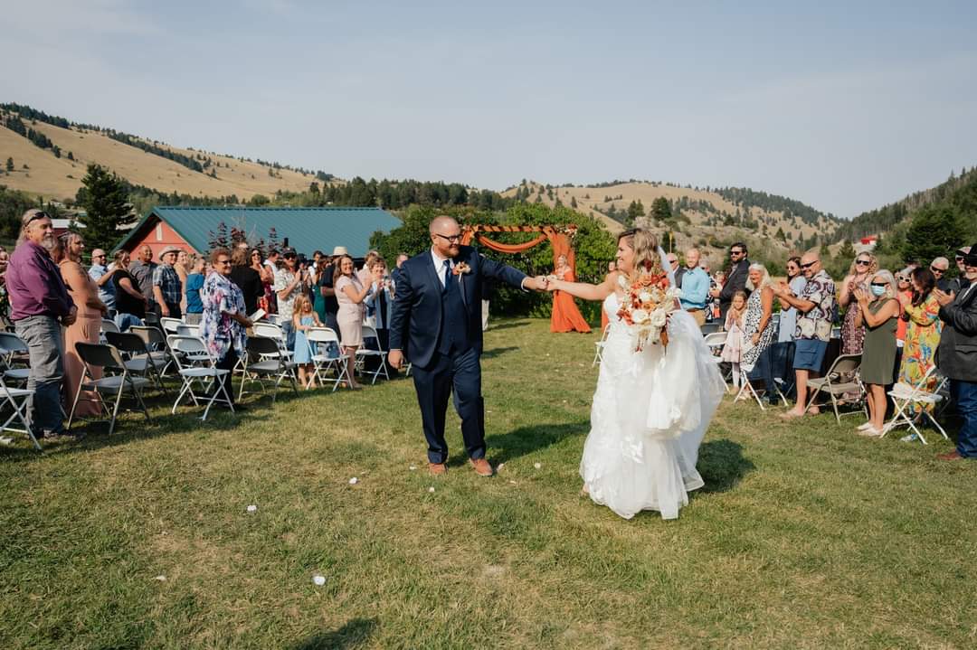 bride and groom walking down aisle in montana mountain wedding