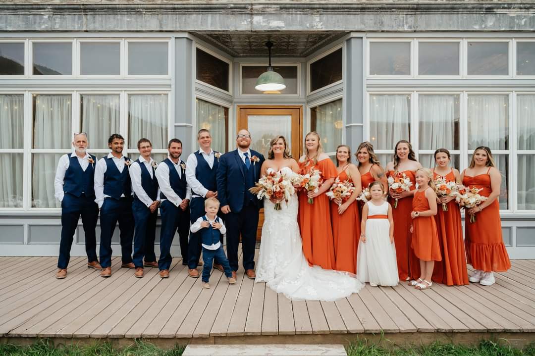 wedding party with bride and groom in front on historic marysville general store